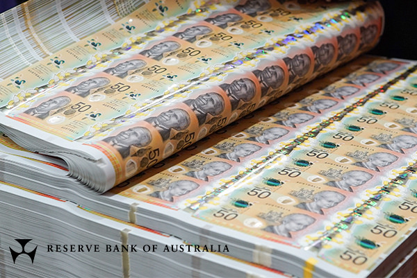 Stacked sheets with new $50 banknotes.